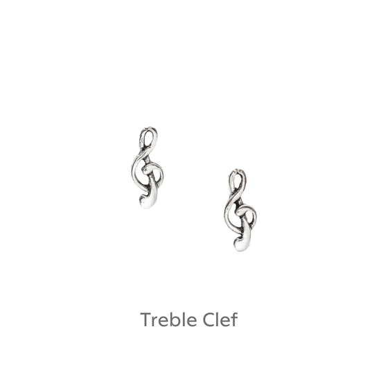 a pair of silver treble earrings on a black background