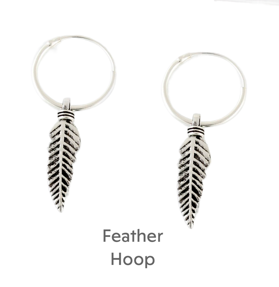 a pair of silver hoop earrings with a leaf charm