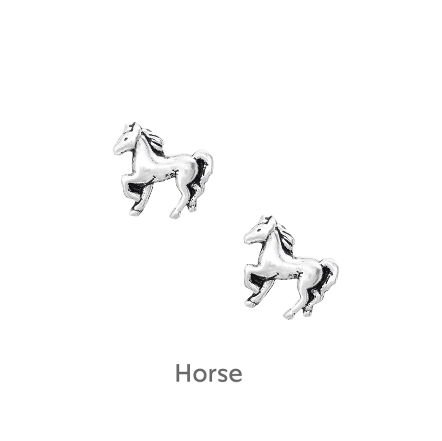 a pair of silver horse earrings on a black background