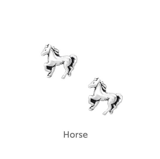 a pair of silver horse earrings on a black background