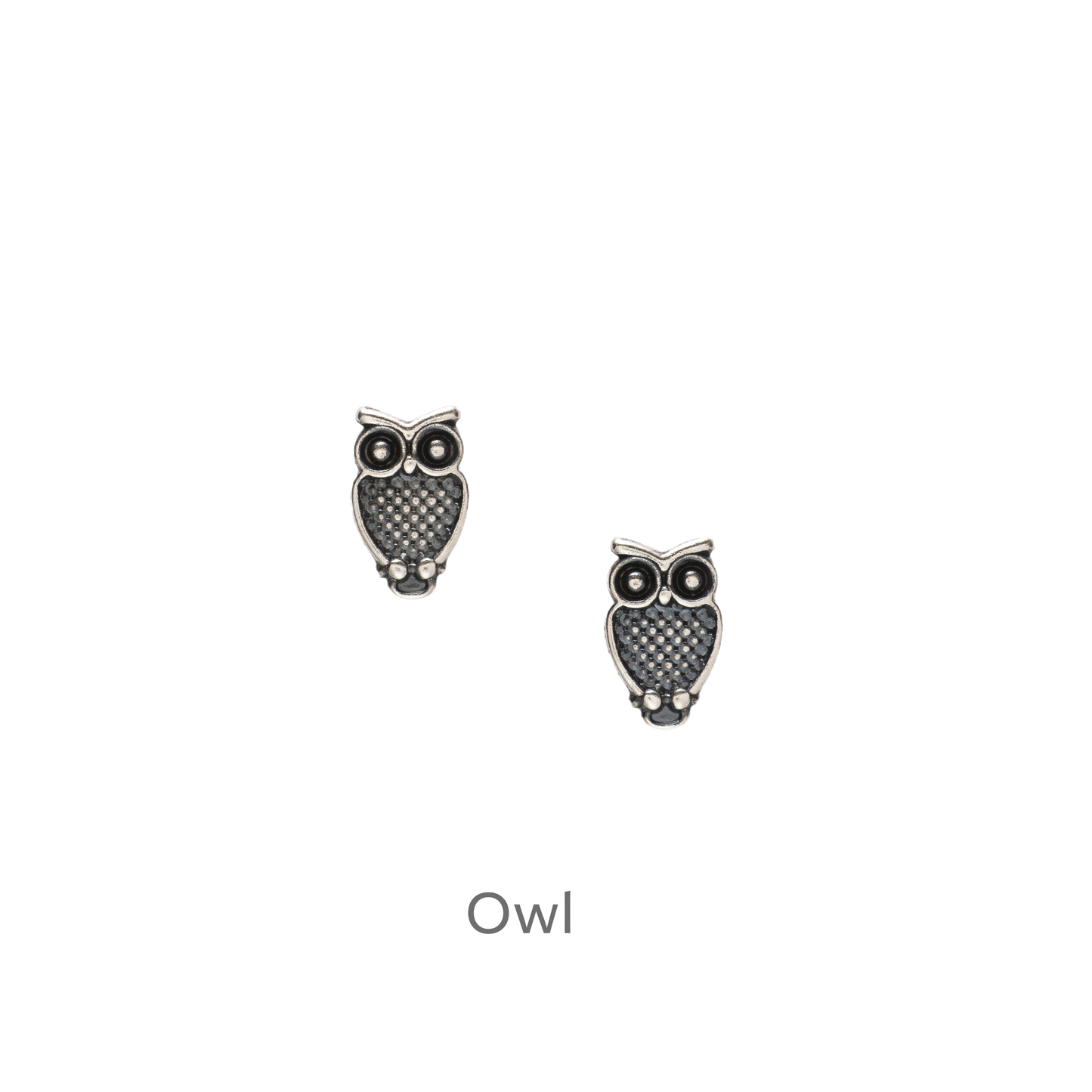 a pair of earrings with an owl design