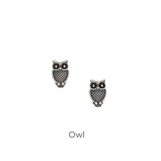 a pair of earrings with an owl design