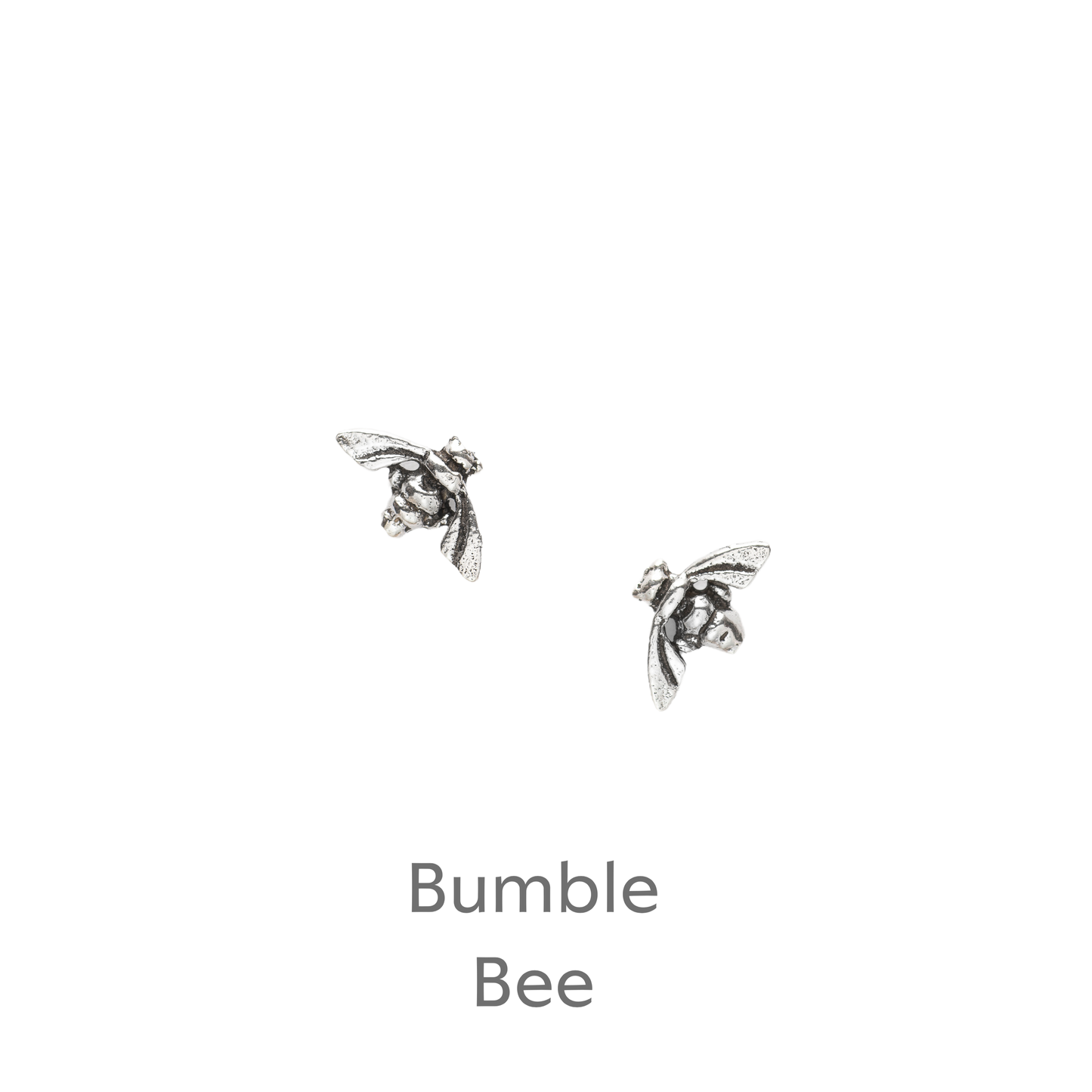 a pair of silver bee earrings on a black background