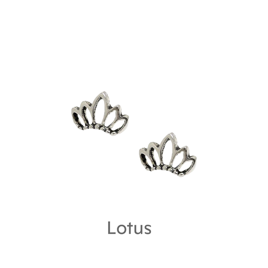 a pair of silver earrings on a black background