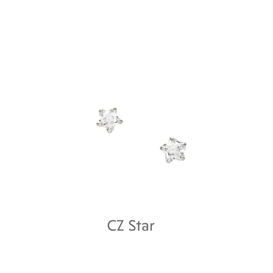 a pair of white diamond earrings on a black background