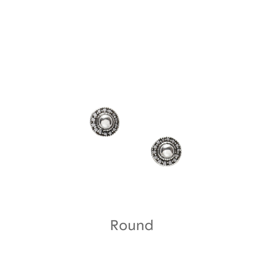 a pair of earrings on a black background