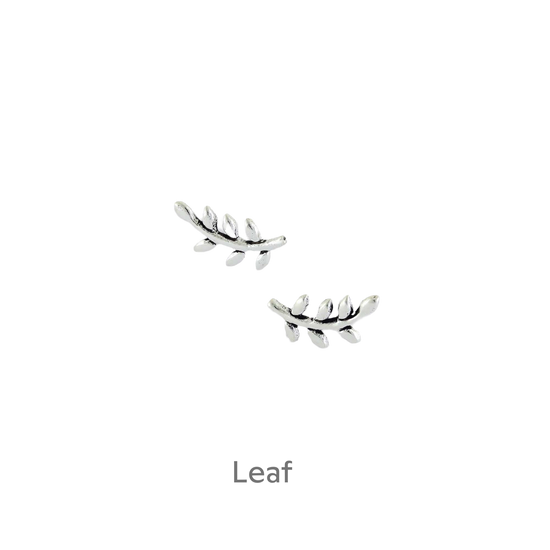 a pair of silver earrings on a black background