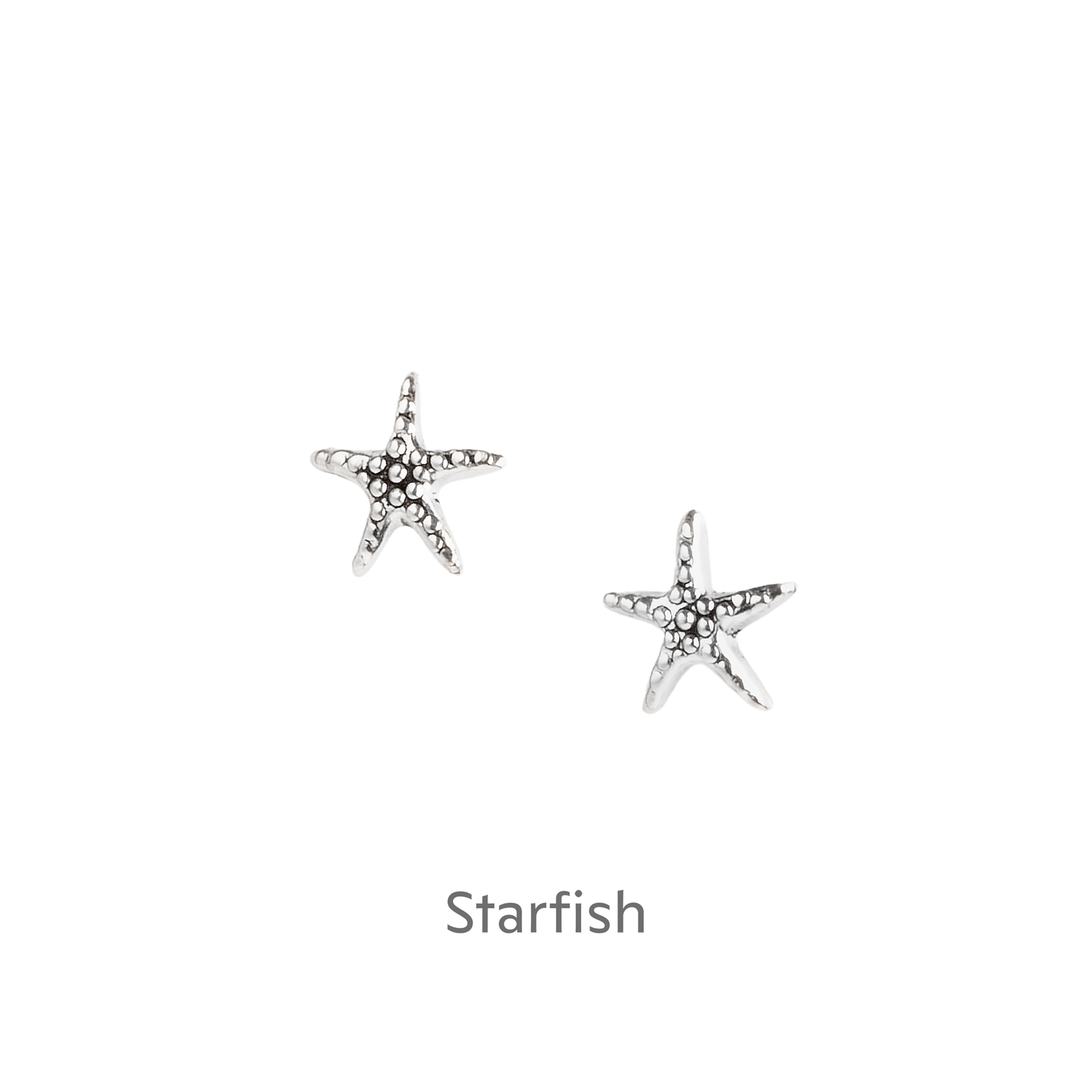 a pair of starfish earrings on a black background