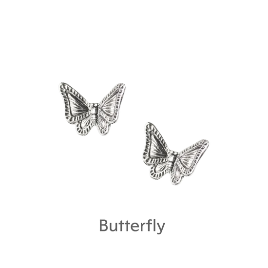 a pair of silver butterflies on a black background