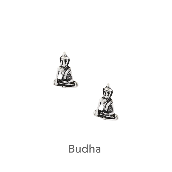 a pair of silver buddha earrings on a black background